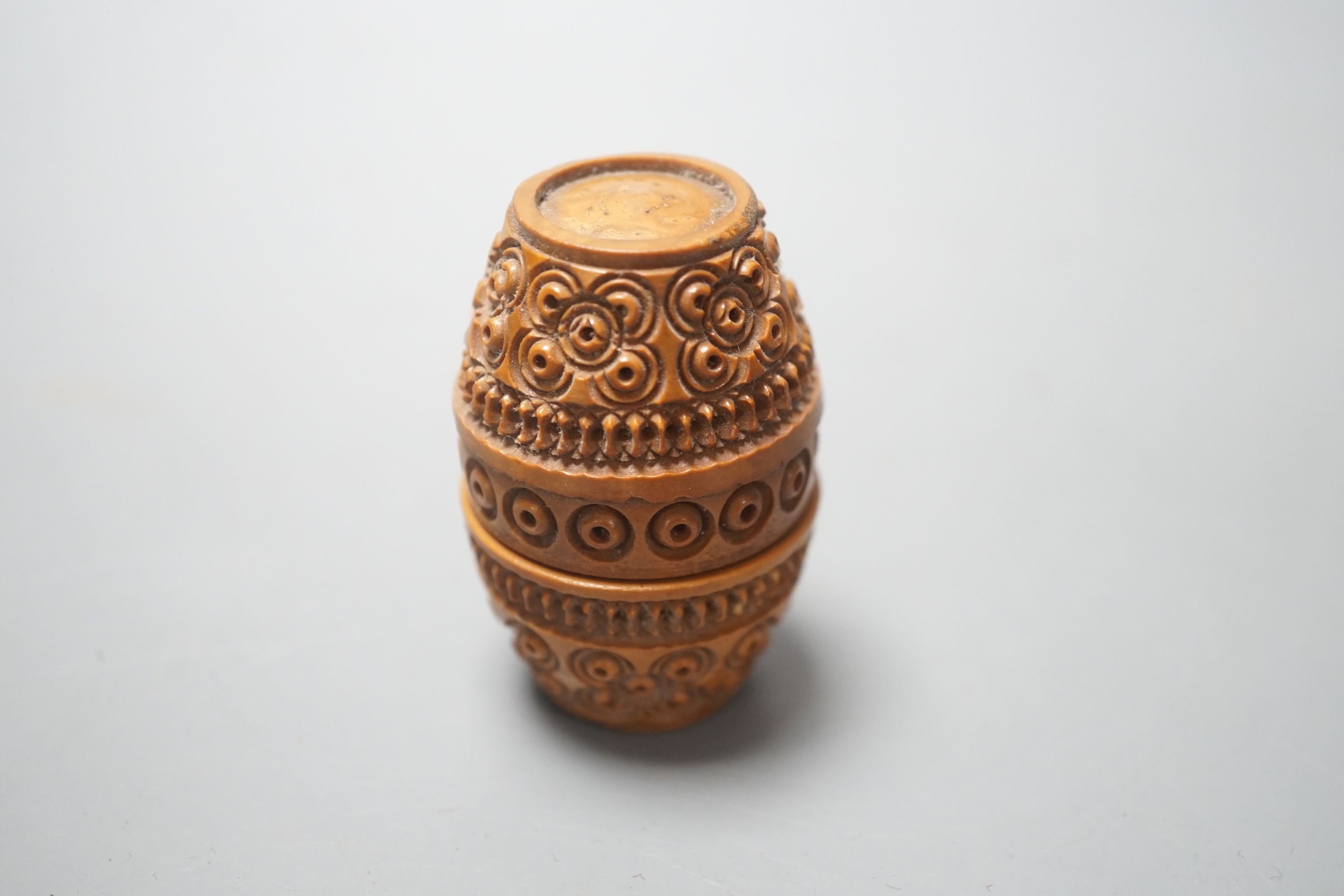 A carved coquilla nut box, 6cms high